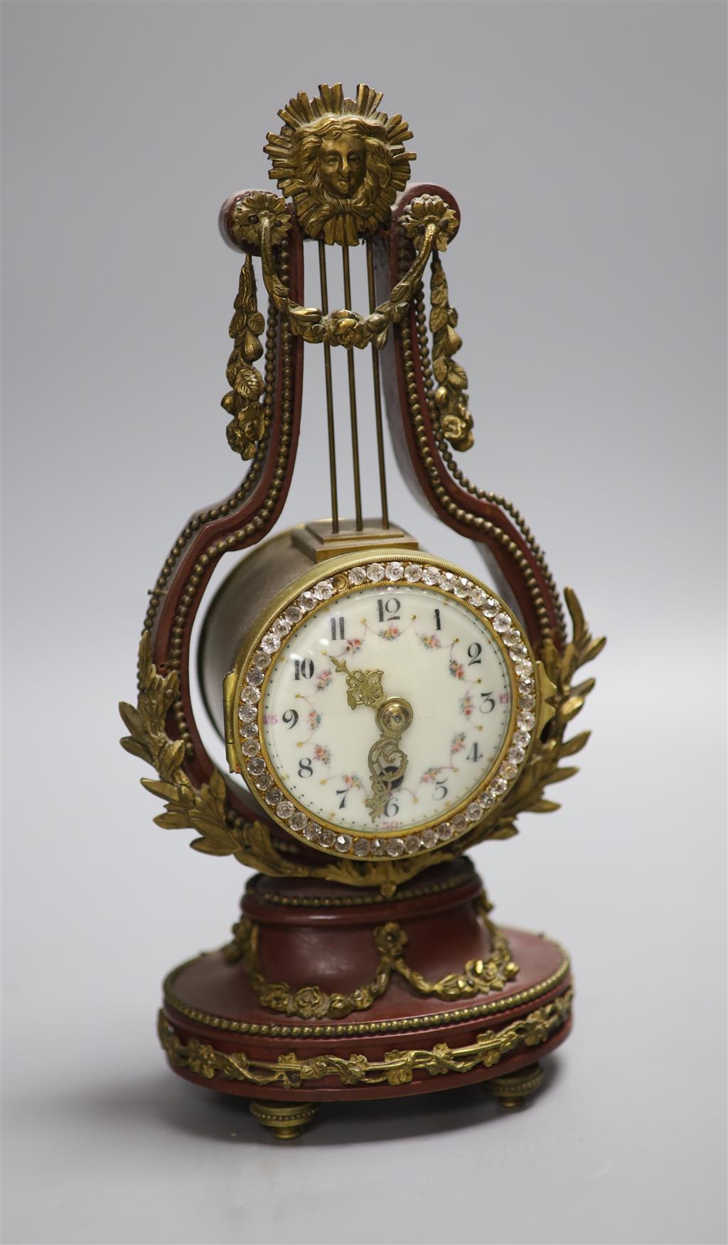 An early 20th century French lyre shaped mantel timepiece, with enamelled dial, height 26.5cm